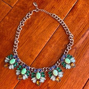 Silver necklace with colorful rhinestones.